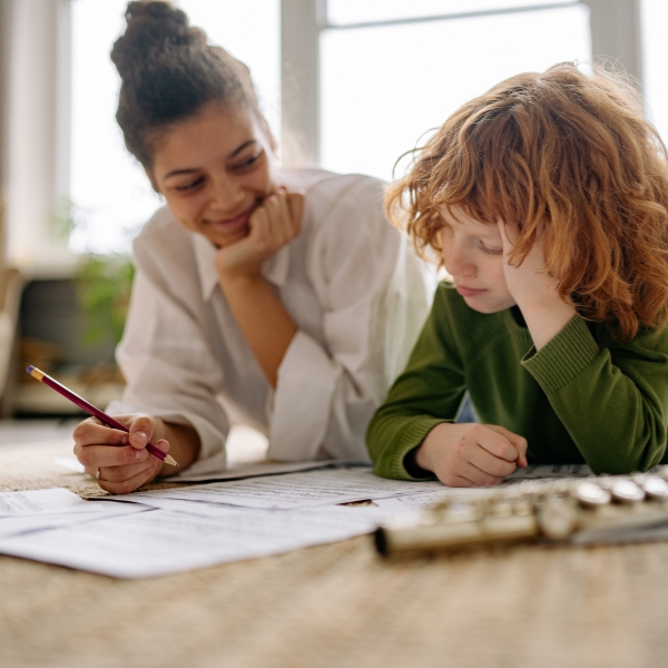 child and tutor looking at papers